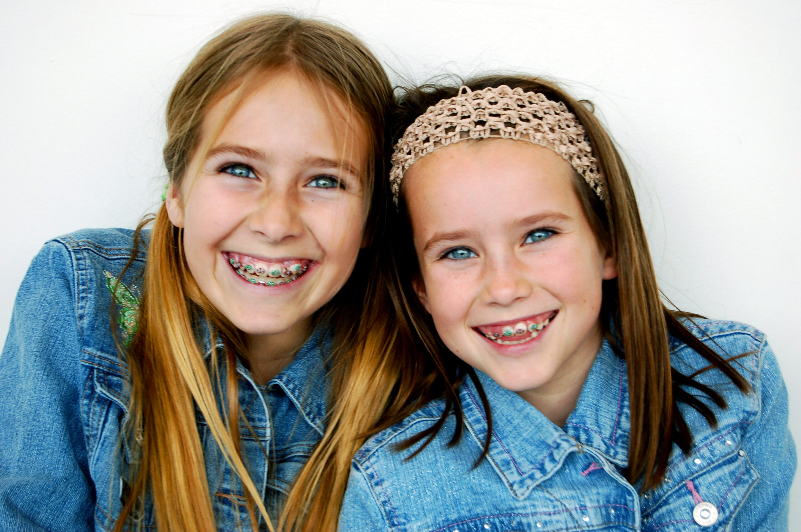 Two young girls smiling with braces at Highland Family Dental in Casper, WY Two young girls smiling with braces at Highland Family Dental in Casper, WY